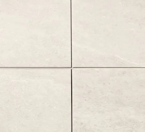 Pale stone-look CeraGrout tiles showing the integrated grout lines at a four-tile junction